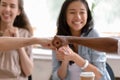 Multiracial caucasian and african buddies fist bumping greeting