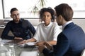 Multiracial colleagues cooperate at meeting in office Royalty Free Stock Photo