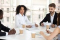 Multiracial colleagues negotiate during briefing in office Royalty Free Stock Photo