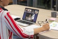 Multiracial colleagues during online meeting with midsection of asian female colleague in office