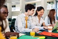 Multiracial college students preparing exams sitting together at cafeteria Royalty Free Stock Photo