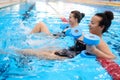 Multiracial couple attending water aerobics class in a swimming pool