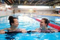 Multiracial couple attending water aerobics class in a swimming pool Royalty Free Stock Photo