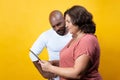 Multiracial couple consulting an electronic device