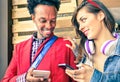 Multiracial couple flirting with smartphone numbers Royalty Free Stock Photo