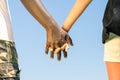 Multiracial couple holding hands - Love against racism