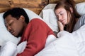 Multiracial couple sleeping in a bed