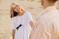 Multiracial couple smiling and holding hands while walking on beach Royalty Free Stock Photo