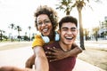 Multiracial couple taking selfie portrait with smartphone mobile outdoor Royalty Free Stock Photo