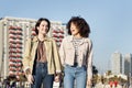 Multiracial couple of women walking and laughing Royalty Free Stock Photo