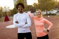 Multiracial couple of young runners resting after training Royalty Free Stock Photo