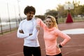 Multiracial couple of young runners resting after training Royalty Free Stock Photo