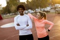 Multiracial couple of young runners resting after training Royalty Free Stock Photo