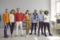 Multiracial diverse young adult people standing together in bright office Royalty Free Stock Photo