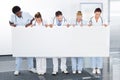 Multiracial doctors holding placard Royalty Free Stock Photo