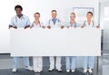 Multiracial doctors holding placard Royalty Free Stock Photo