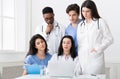 Multiracial doctors looking at laptop, working together in clinic Royalty Free Stock Photo