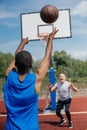 multiracial elderly men playing basketball together on playground Royalty Free Stock Photo