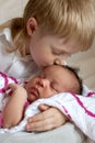 Multiracial family concept. Brother kissing newborn