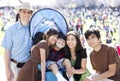 Multiracial family in crowd with disabled child in wheelchair