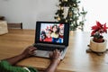 Multiracial family doing video call during Christmas time - Focus on right hand