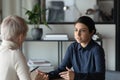 Multiracial female colleagues discuss ideas at meeting Royalty Free Stock Photo