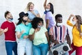 Multiracial friends dancing to music with boombox stereo outdoor with masks under chins - Focus on black man Royalty Free Stock Photo