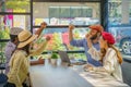 Multiracial friends or group of tourist having arms raise together during sitting in coffee shop Royalty Free Stock Photo