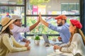 Multiracial friends or group of tourist having high five together during sitting in coffee shop in city Royalty Free Stock Photo