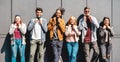 Multiracial friends smiling with face mask after lockdown reopening - Happy guys and girls having fun around city streets