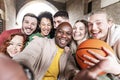 Multiracial friends taking selfie group photo outside - Friendship concept with guys and girls having fun together on city street Royalty Free Stock Photo