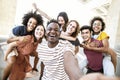 Multiracial friends taking selfie group picture with smart mobile phone outside on city street Royalty Free Stock Photo