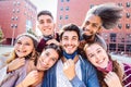 Multiracial friends taking selfie with opened face mask at college campus - Happy friendship concept with young students Royalty Free Stock Photo