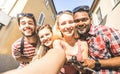 Multiracial friends taking selfie outdoors - Happy friendship concept with young students having fun together - Millenial people Royalty Free Stock Photo