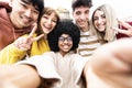 Multiracial friends taking selfie photo outside - Different group of young people laughing together looking at camera Royalty Free Stock Photo