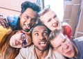 Multiracial millenial friends taking selfie sticking out tongue with funny faces - Happy friendship concept against racism Royalty Free Stock Photo