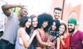 Multiracial friends taking video selfie with mobile phone on stabilized gimbal - Young people having fun on new tech trends Royalty Free Stock Photo