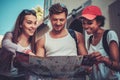 Multiracial friends tourists with map