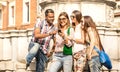 Multiracial friends using mobile smart phone at city tour - Happy friendship concept with student having fun together - Millenial Royalty Free Stock Photo