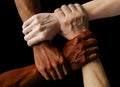 Multiracial group with black african American Caucasian and Asian hands holding each other wrist in tolerance unity love and anti Royalty Free Stock Photo