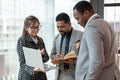 A multiracial group of business people. discussing work while standing in a company corridor Royalty Free Stock Photo