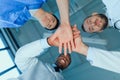 Multiracial group of doctors holding hands together in clinic Royalty Free Stock Photo