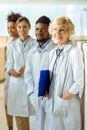 A multiracial group of doctors in lab coats standing in a Royalty Free Stock Photo