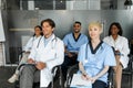 Multiracial group of doctors in workwear attending medical conference Royalty Free Stock Photo