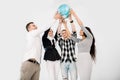 Multiracial group of four young cheerful people holding up the Earth Globe. Young people holding up a globe standing on Royalty Free Stock Photo