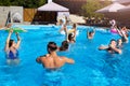 Multiracial group of friends having party in private villa swimming pool. Happy young people in swimwear dancing and Royalty Free Stock Photo