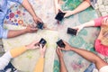 Multiracial group of friends mobile addicted - Wifi connected people in bar table meeting - Top view hands circle using mobile Royalty Free Stock Photo