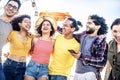Multiracial group of friends smiling together hanging outside on a sunny day - Happy young people having fun on summer vacation Royalty Free Stock Photo