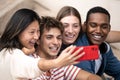 Multiracial group of friends taking a selfie outside.Young beautiful people taking a picture smiling and sitting in Royalty Free Stock Photo