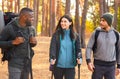 Multiracial group of hikers having fun while backpacking at forest